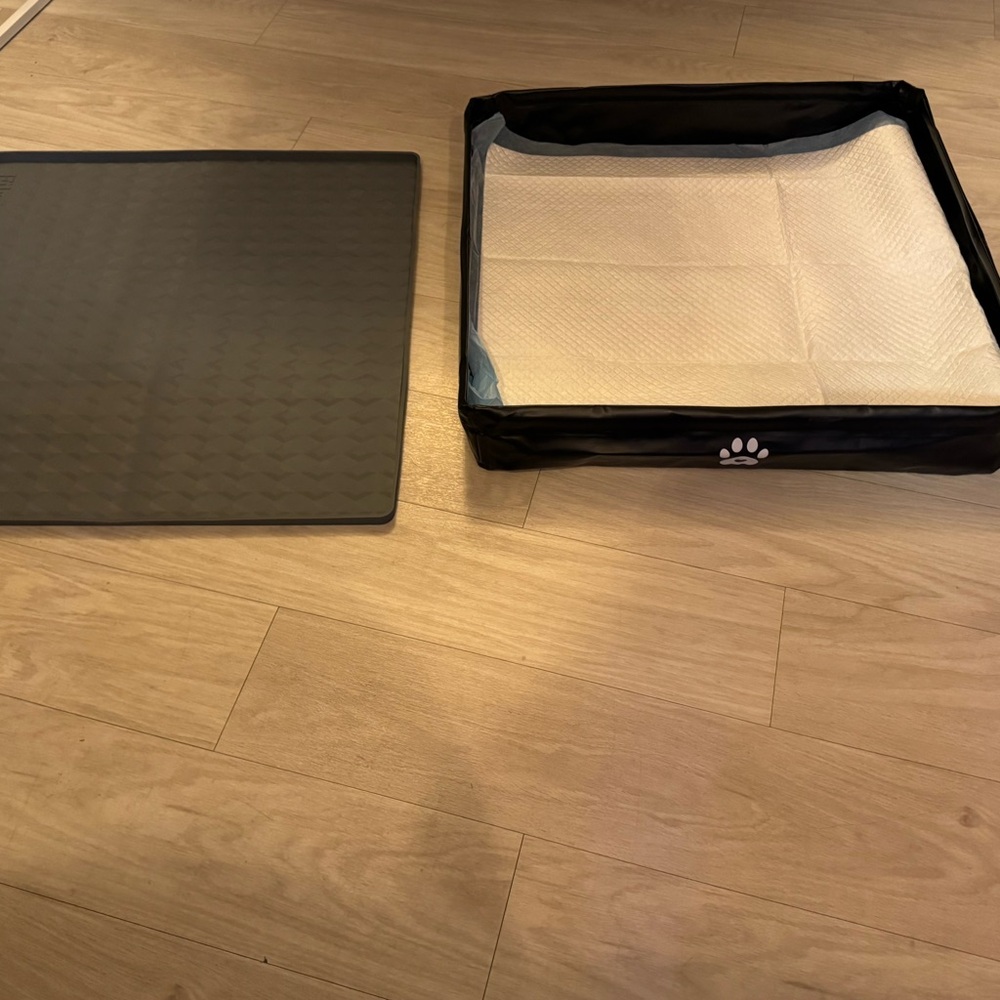 Dog potty pad holders trays bundle.  One is black and one is gray.